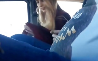 Fair-haired lassie is rubbing his cock in a car and blows it deep throat